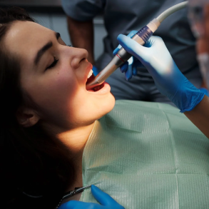 Patient during dental treatment with dentist on the chair