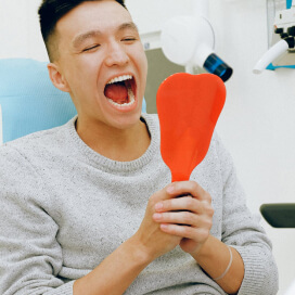 Patient with his mouth wide open at dentist