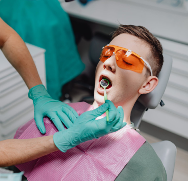 Guy at dentist - teeth examination